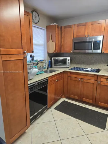 a kitchen with a sink stove and microwave