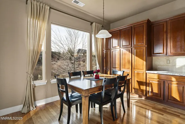 a view of a dining room with furniture window and wooden floor