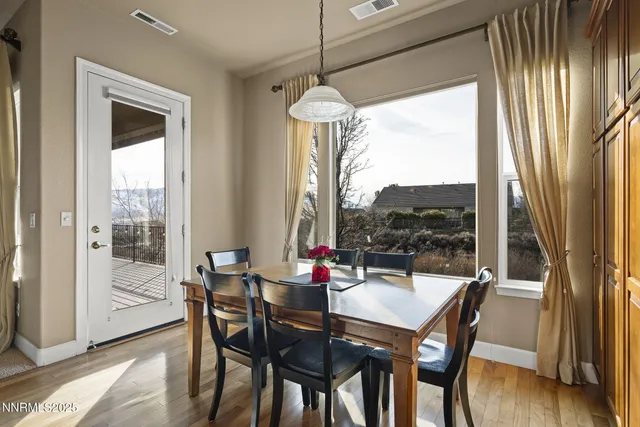 a dining room with furniture a chandelier and window