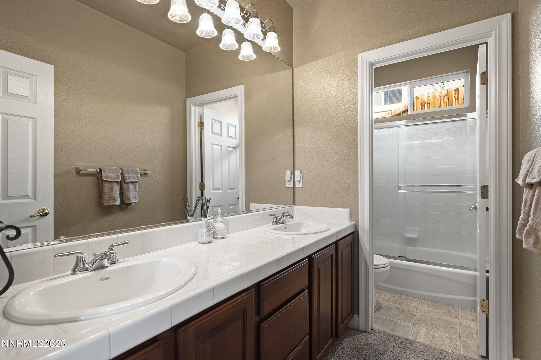 2757 Robb Drive Reno, NV 89523 - Photo 25 of 51 a bathroom with a double vanity sink and a mirror