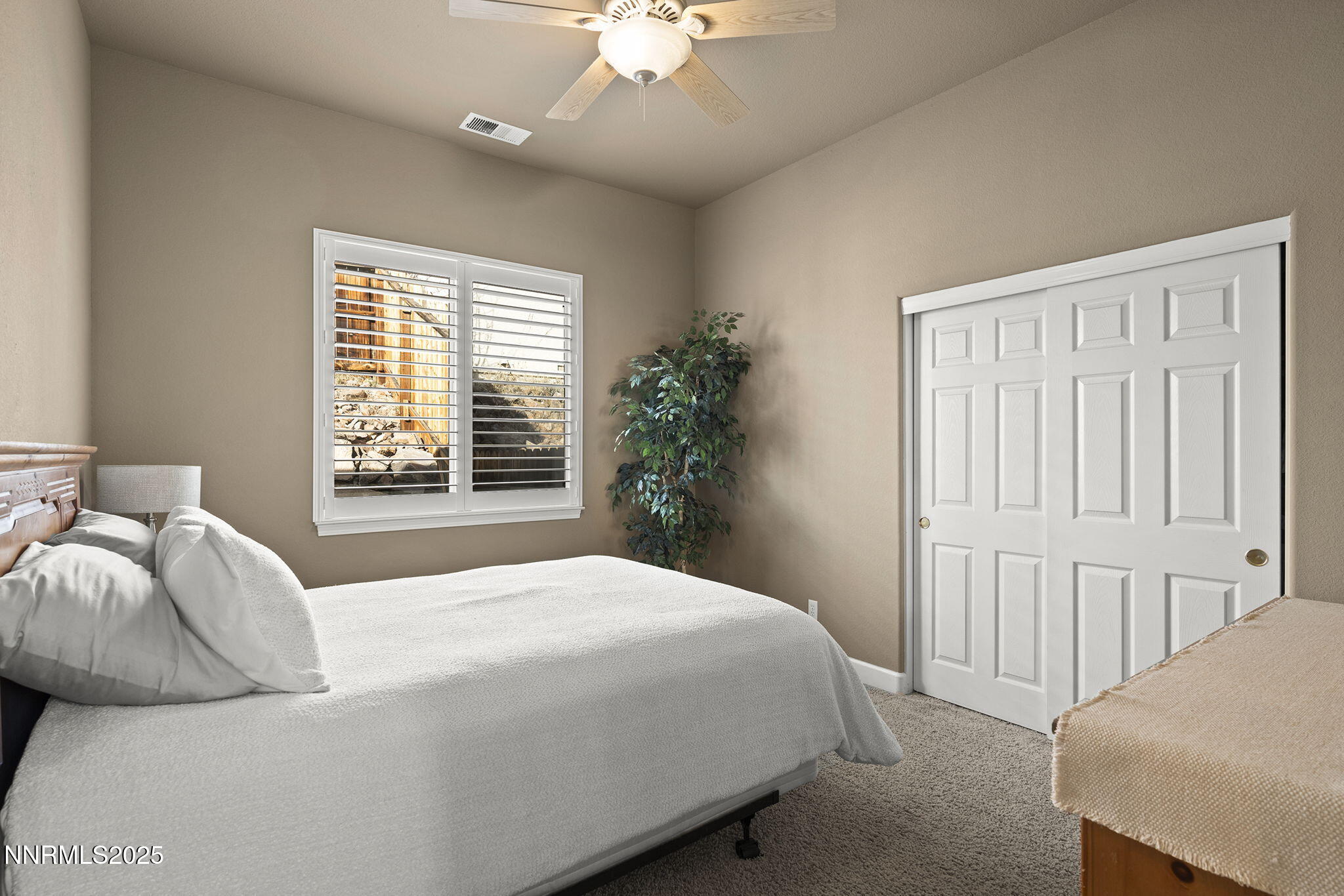 2757 Robb Drive Reno, NV 89523 - Photo 26 of 51 a bedroom with a large bed and a chandelier fan