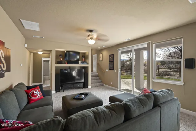 a living room with lots of furniture and a large window