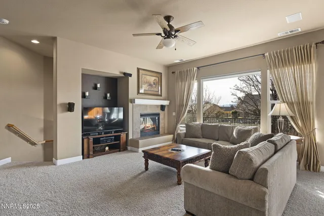 a living room with furniture a large window and a flat screen tv