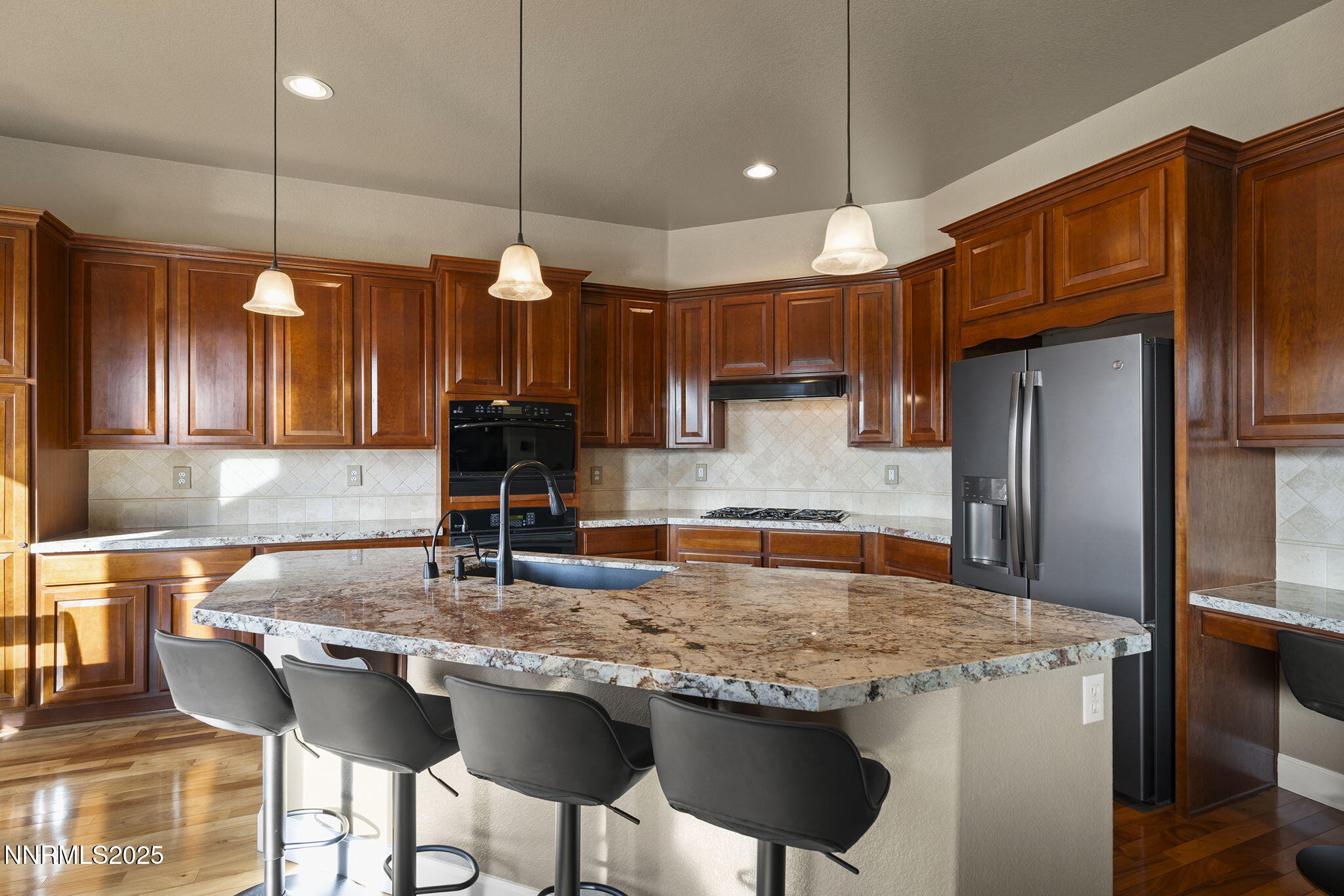 2757 Robb Drive Reno, NV 89523 - Photo 10 of 51 a kitchen with kitchen island granite countertop a stove a sink island and a refrigerator