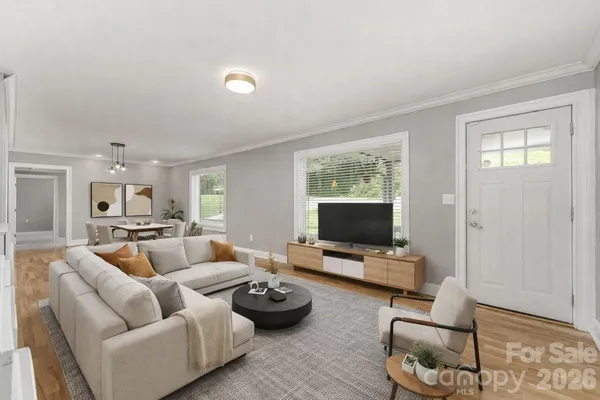 a living room with furniture and a flat screen tv