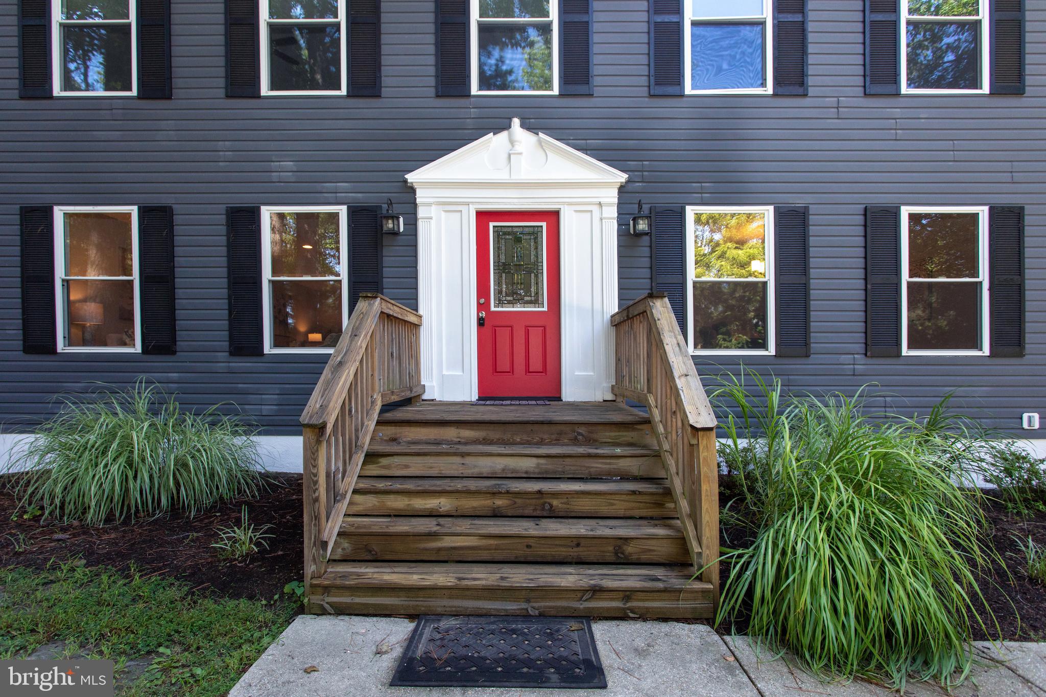 a front view of a house with a garden