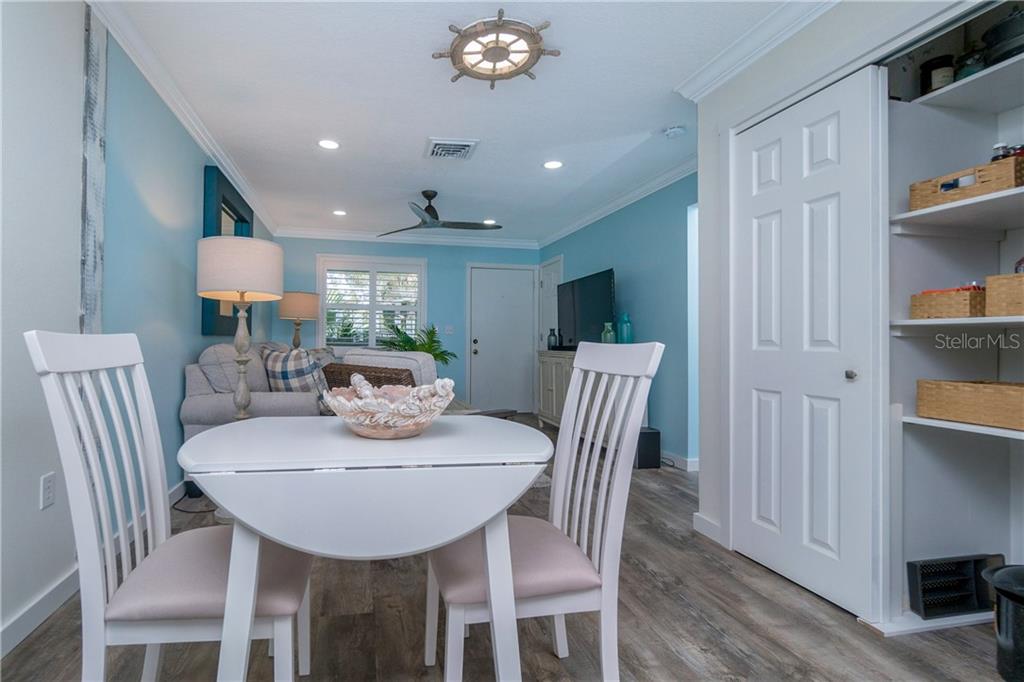 5041 North Beach Road, Unit 3A Englewood, FL 34223 - Photo 11 of 52 a view of a dining room with furniture and chandelier