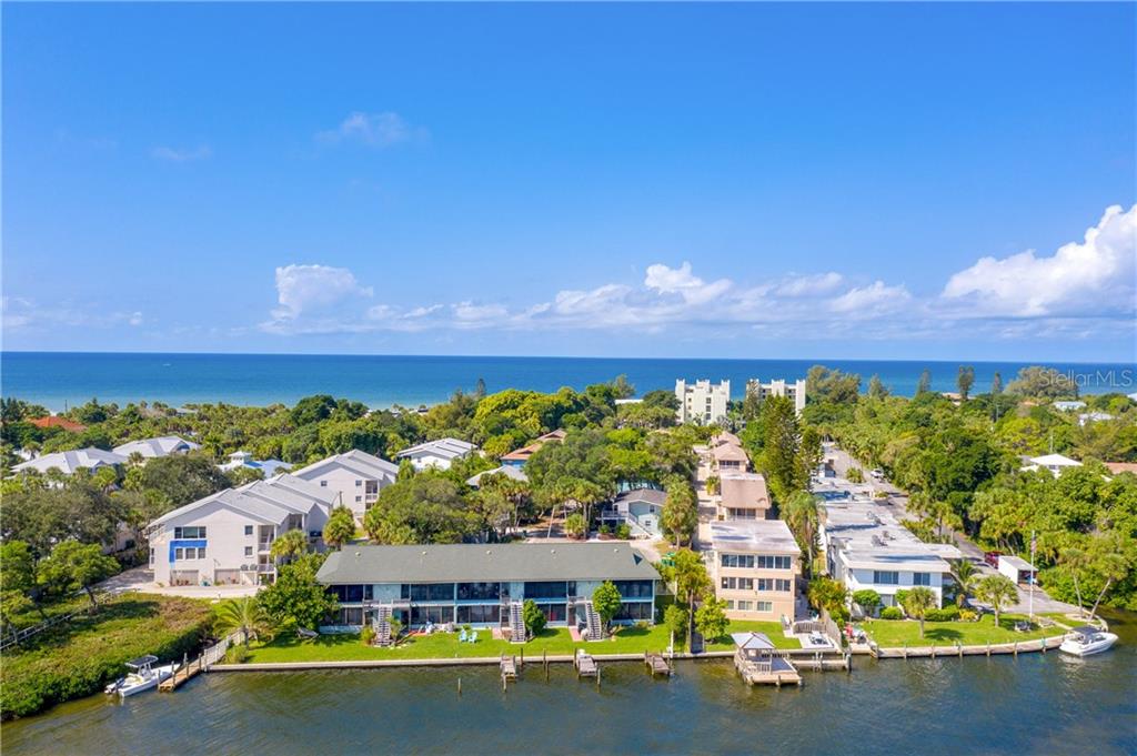 5041 North Beach Road, Unit 3A Englewood, FL 34223 - Photo 43 of 52 a view of a swimming pool with lawn chairs and flower plants