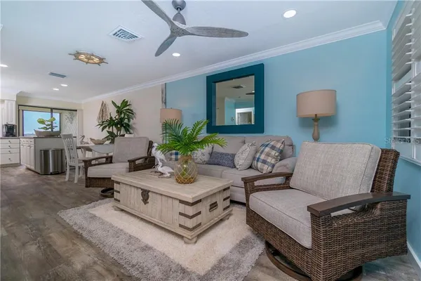 a living room with furniture potted plant and a lamp