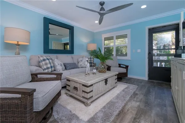 a living room with furniture and wooden floor