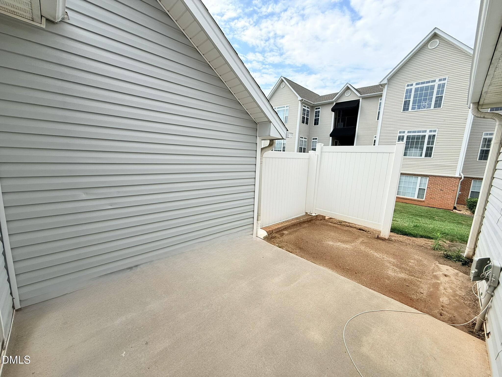 11381 Involute Place, Unit 103 Raleigh, NC 27617 - Photo 25 of 25 a view of a white house with a yard and garage