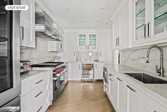 a kitchen with stainless steel appliances granite countertop a stove and a sink