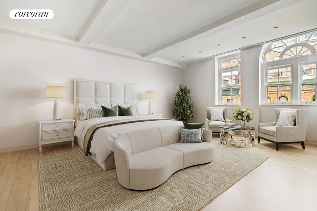 a bedroom with bed and a couch