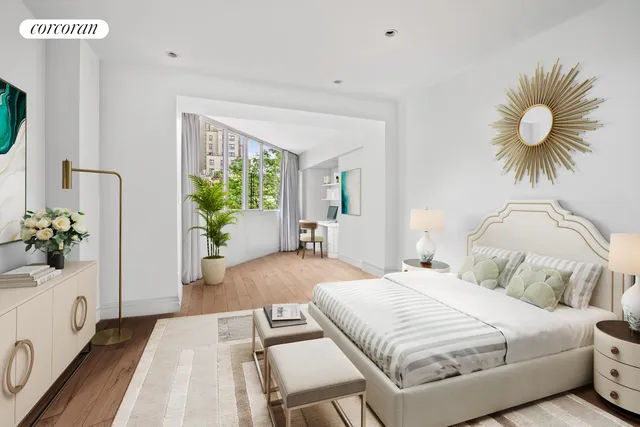 a bedroom with a large bed and a potted plant