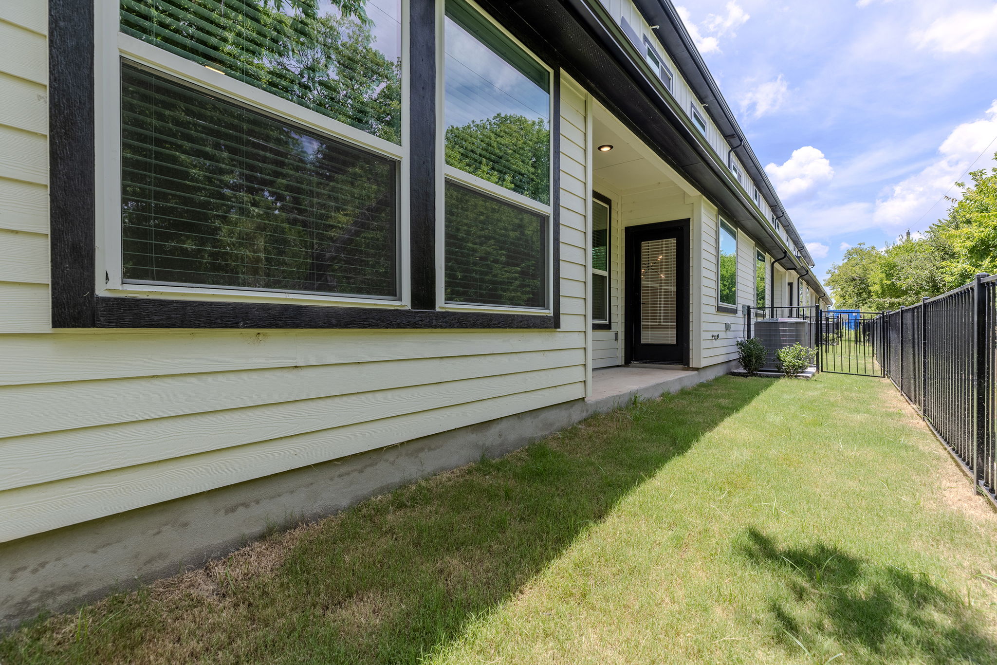 2600 Gattis School Road, Unit 1001 Round Rock, TX 78664 - Photo 33 of 40 A private side yard with verdant grass offers a quiet outdoor retreat.