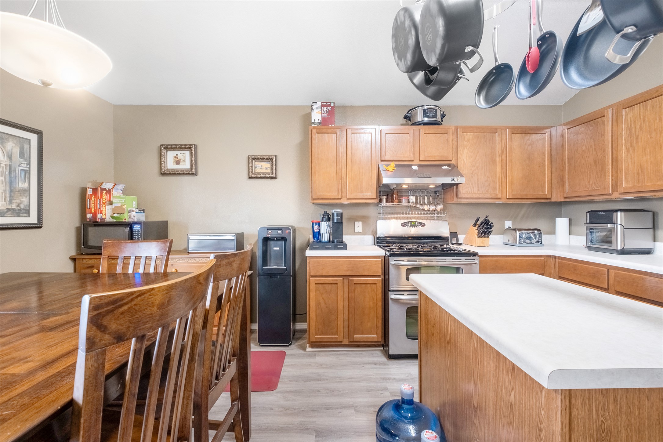 745 Caylor Cove Bastrop, TX 78602 - Photo 12 of 40 The kitchen at 745 Caylor Cove in Bastrop, TX is both stylish and functional, featuring a center island that adds extra counter space. With an open layout that flows into the dining and living areas, this kitchen is perfect for cooking, entertaining, or gathering with family. Bright, airy, and practical, it’s an ideal space for buyers looking for a Bastrop home for sale with an open-concept kitchen and island.