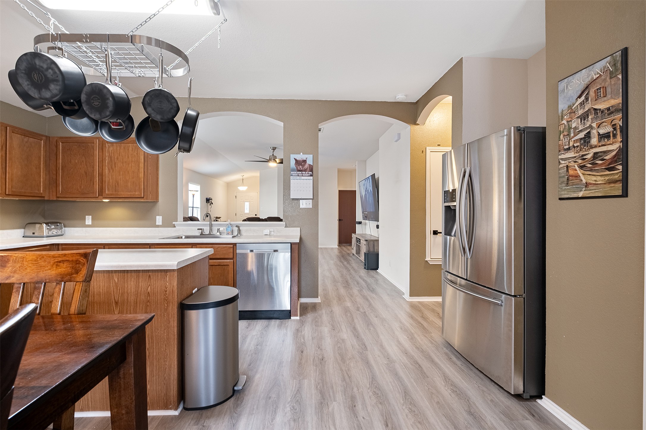 745 Caylor Cove Bastrop, TX 78602 - Photo 17 of 38 a kitchen with stainless steel appliances granite countertop a refrigerator a sink dishwasher a stove and white countertops with wooden floor
