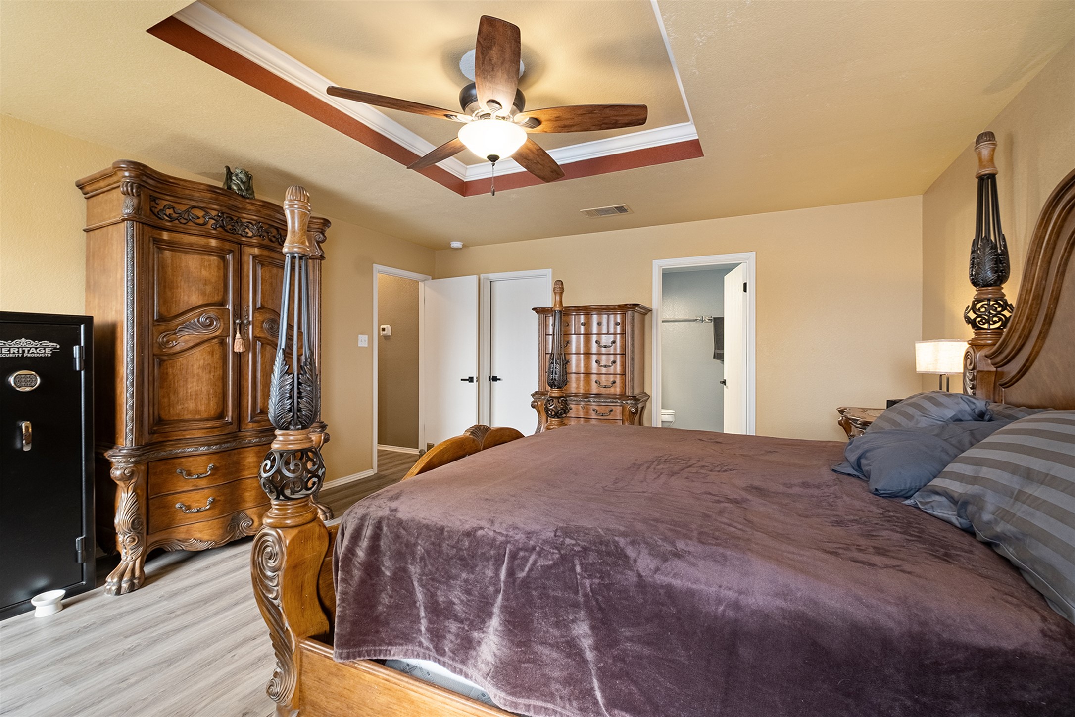 745 Caylor Cove Bastrop, TX 78602 - Photo 23 of 38 a bedroom with a bed dresser and a walk in closet