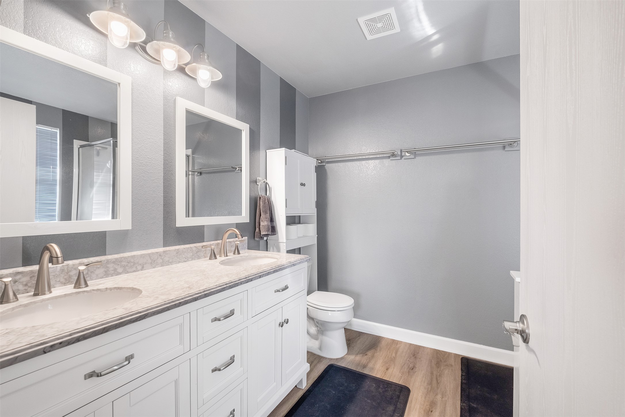 745 Caylor Cove Bastrop, TX 78602 - Photo 23 of 40 The primary bathroom features updated double vanities, providing plenty of space for two and a modern, functional design. Bright and stylish, this bathroom complements the primary suite with a clean layout and contemporary finishes. Ideal for buyers searching for a Bastrop home for sale with a spacious, updated primary bathroom, it combines convenience, comfort, and style.