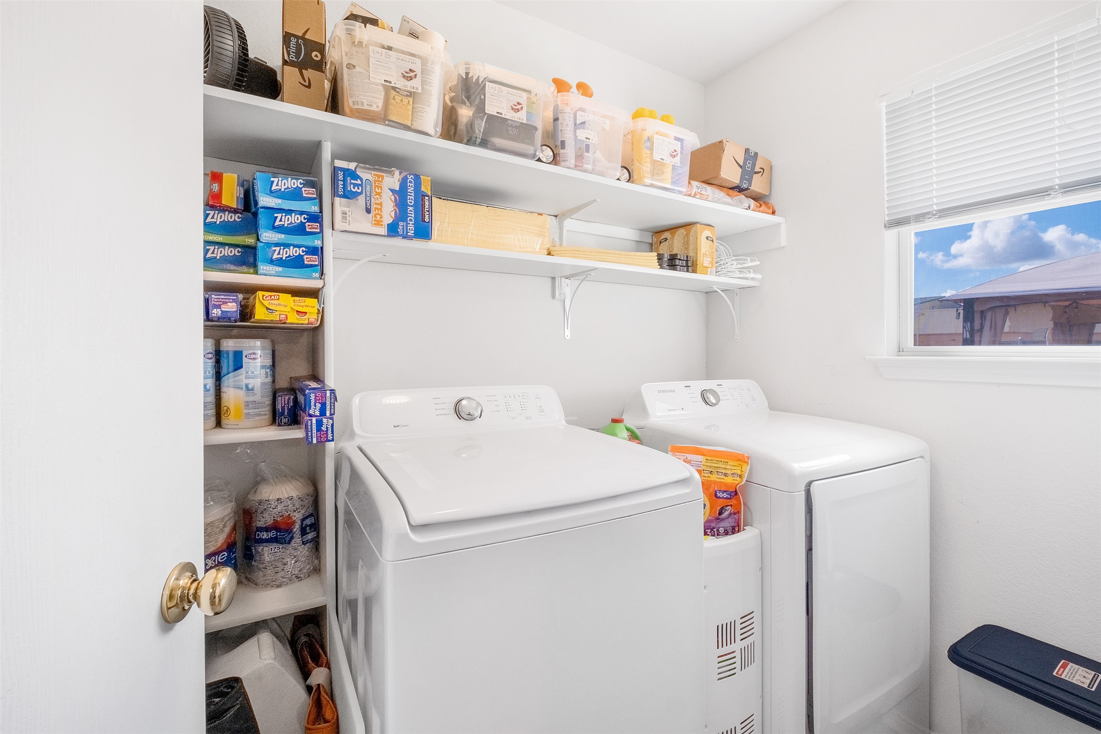 745 Caylor Cove Bastrop, TX 78602 - Photo 26 of 40 This laundry room, conveniently located off the kitchen, features a dedicated door to keep noise contained, making household chores more manageable. With functional space for washer, dryer, and storage, it’s both practical and efficient. Ideal for buyers searching for a Bastrop home for sale with a well-designed laundry area, this space adds convenience and ease to everyday living.