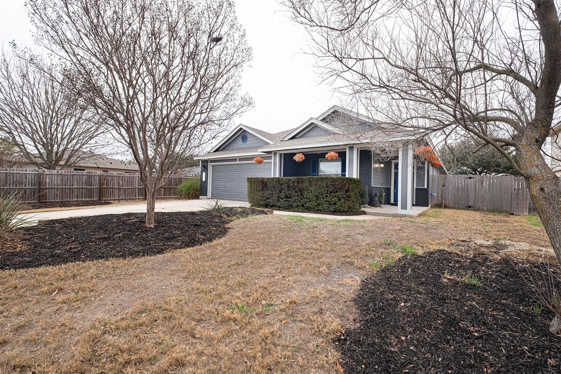 745 Caylor Cove Bastrop, TX 78602 - Photo 6 of 38 a front view of a house with a yard covered in snow