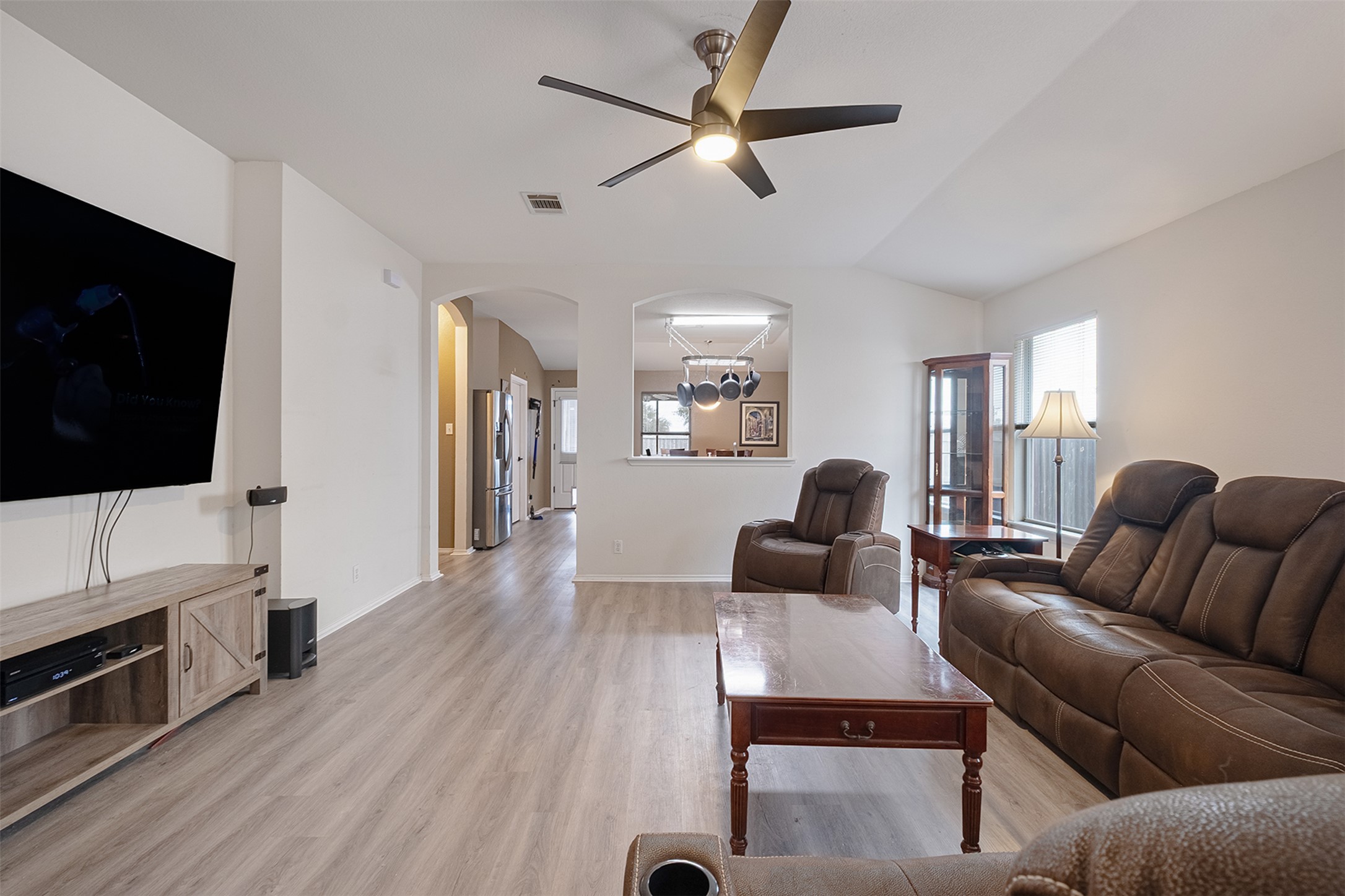 745 Caylor Cove Bastrop, TX 78602 - Photo 8 of 38 a living room with furniture a flat screen tv and a fireplace