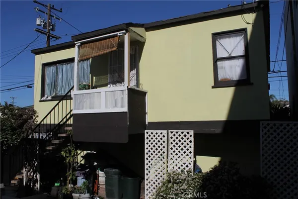 a front view of a house with wooden fence