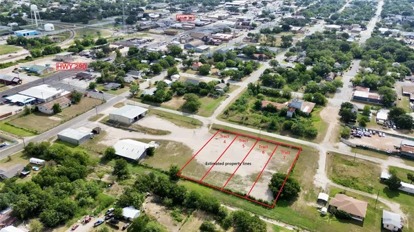 an aerial view of residential houses with outdoor space and street view