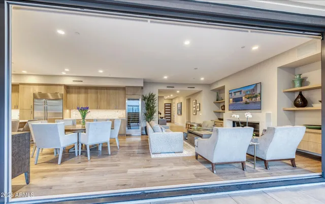 a living room with lots of furniture and a painting on the wall