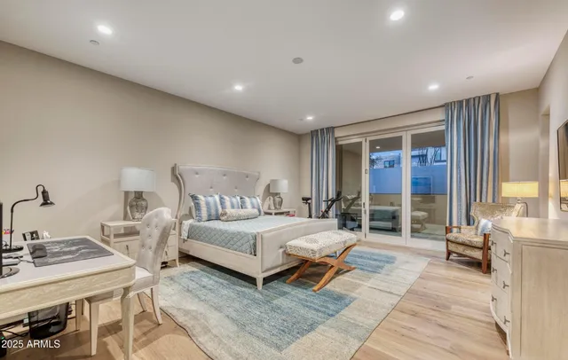 a spacious bedroom with a bed and glass door