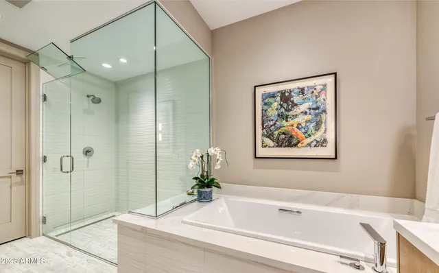 a bathroom with a tub and shower