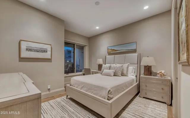 a bedroom with a large bed and a couch