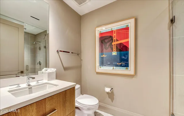 a bathroom with a sink vanity and toilet