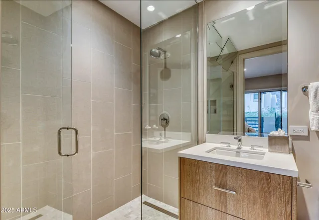 a bathroom with a sink double vanity and shower