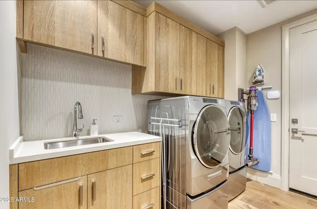 a utility room with sink dryer and washer