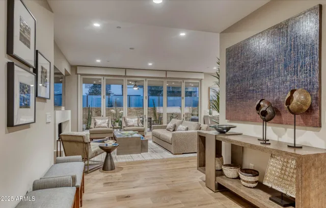 a living room with furniture and a floor to ceiling window