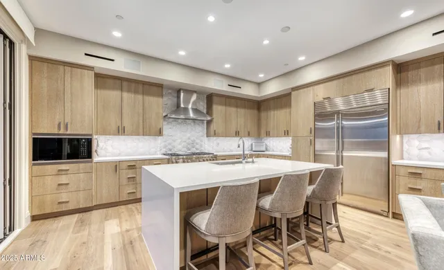 a kitchen with kitchen island a sink table and chairs
