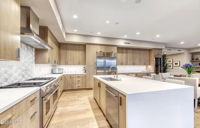 a kitchen with a sink stove and cabinets