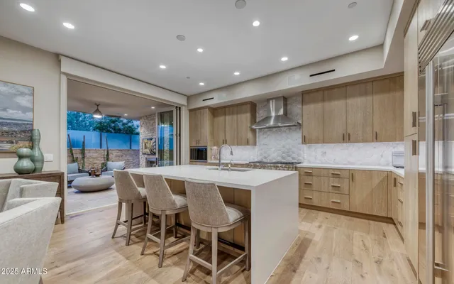 a kitchen with center island cabinets and refrigerator