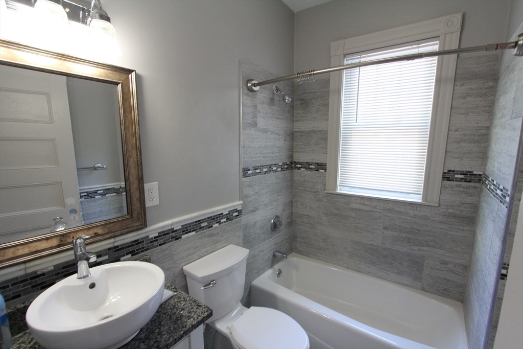 31 Dunreath Street, Unit 1 Boston, MA 02119 - Photo 11 of 11 a bathroom with a sink toilet and shower