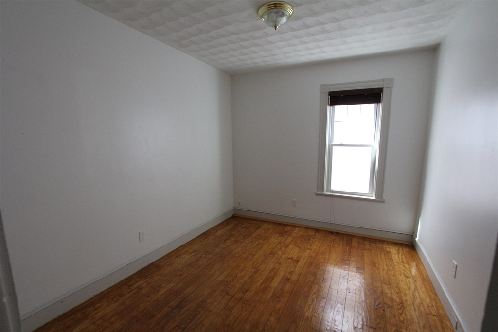 31 Dunreath Street, Unit 1 Boston, MA 02119 - Photo 7 of 11 an empty room with a window