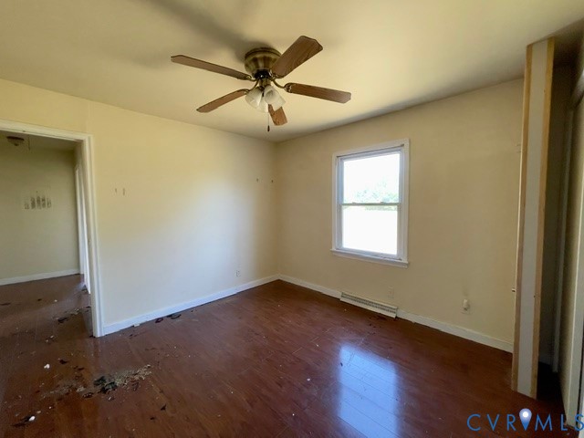 10024 South Hill Road Kenbridge, VA 23944 - Photo 19 of 32 an empty room with wooden floor fan and windows