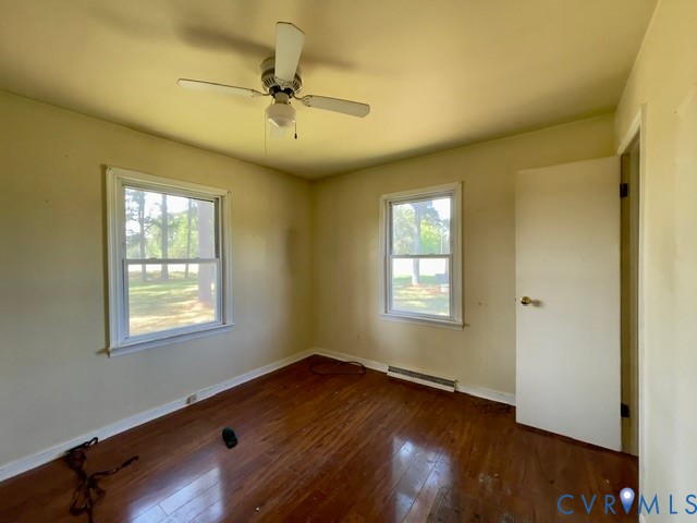 10024 South Hill Road Kenbridge, VA 23944 - Photo 24 of 32 a view of an empty room with wooden floor and a window