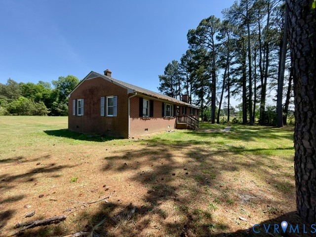 10024 South Hill Road Kenbridge, VA 23944 - Photo 32 of 32 a front view of a house with a yard and trees