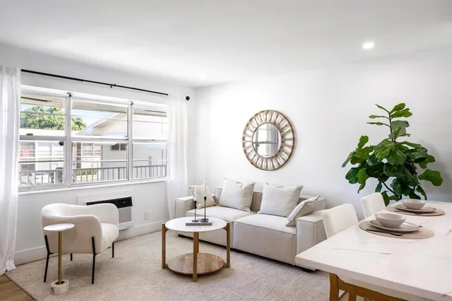 a living room with furniture a window and a large window
