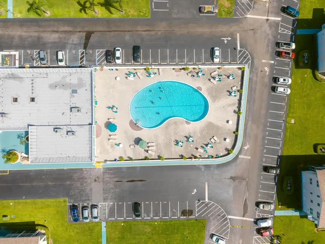 an aerial view of a house with a swimming pool