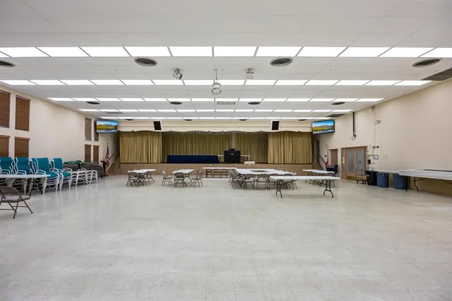 a living room with furniture and a kitchen