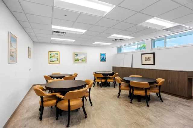 a outdoor room with furniture a rug and a potted plant