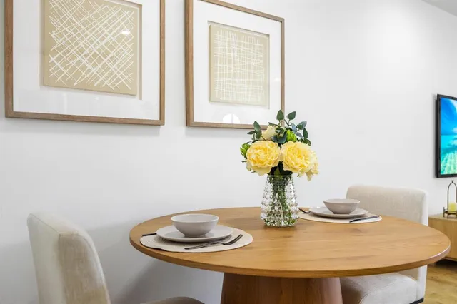 a view of a dining room with furniture and a potted plant