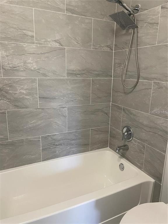 199 Afton Square, Unit 309 Altamonte Springs, FL 32714 - Photo 16 of 17 a bathroom with a bathtub and a shower